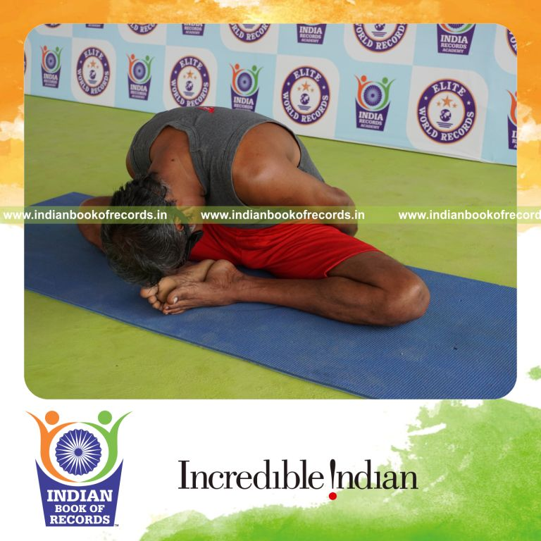 individual holding badha goburasana yoga pose blindfolded for record in Indian Book of Records