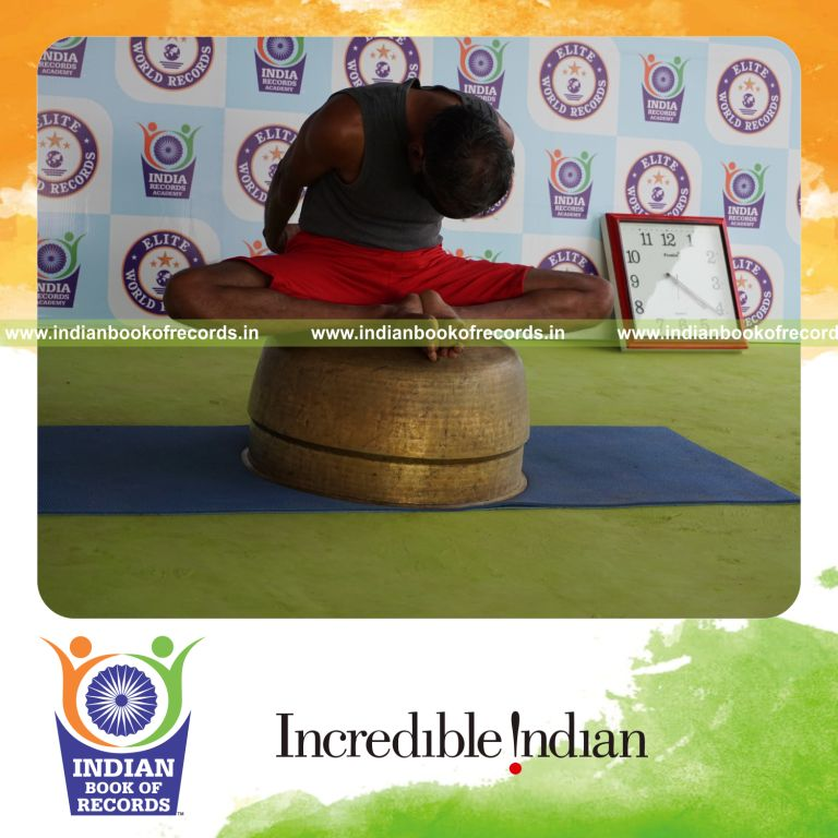 individual holding badha goburasana yoga pose blindfolded on a vessel for record in Indian Book of Records
