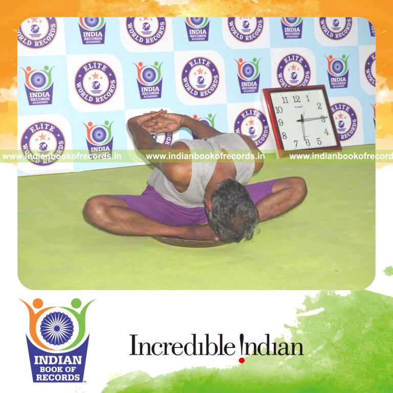 individual holding badha goburasana yoga pose on a brass plate for record in Indian Book of Records