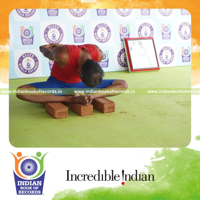 individual holding badha goburasana yoga pose on bricks for record in Indian Book of Records