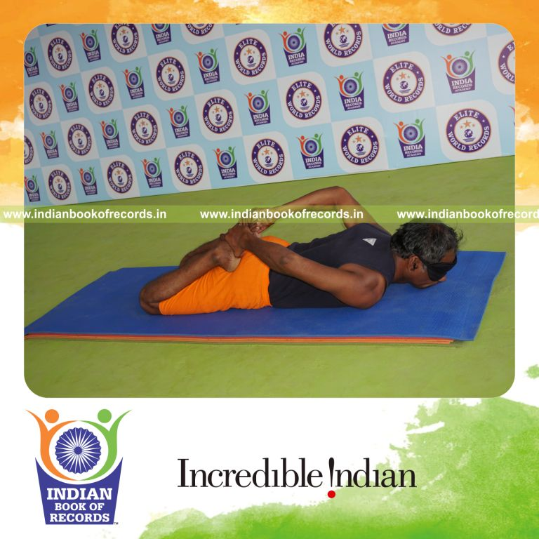 individual holding bhekasana yoga pose blindfolded for record in Indian Book of Records