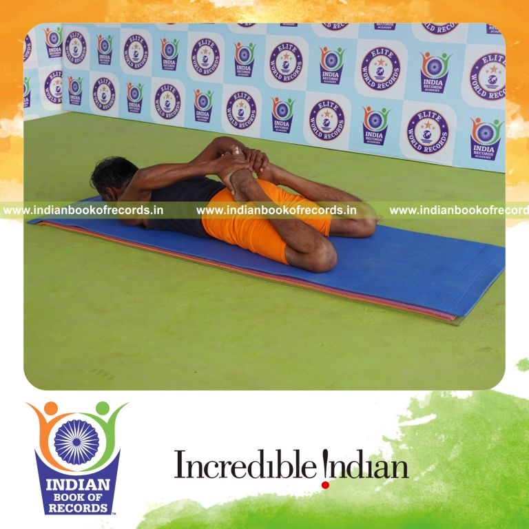 individual holding bhekasana yoga pose for record in Indian Book of Records