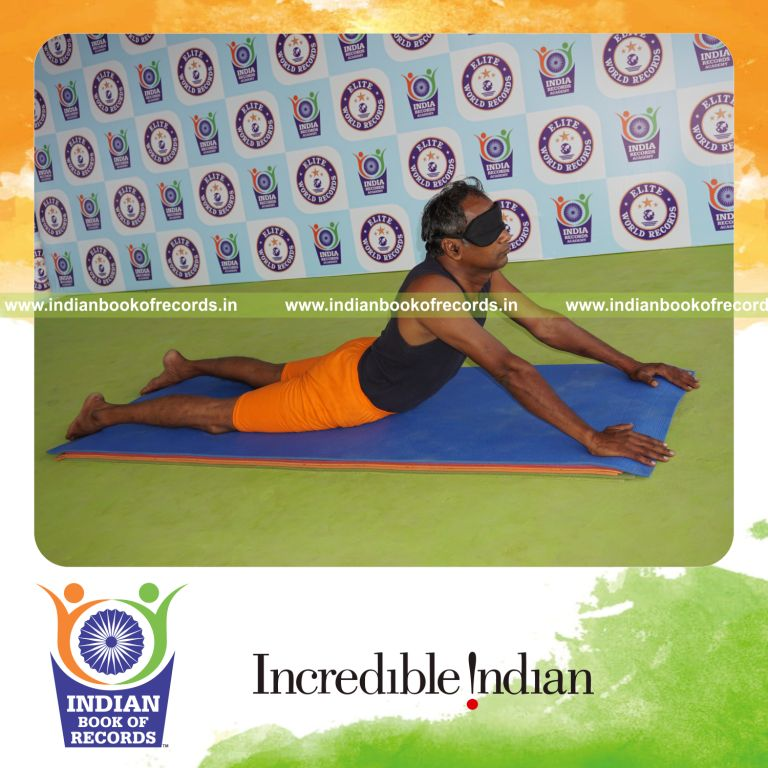 individual holding bhujangasana yoga pose blindfolded for record in Indian Book of Records