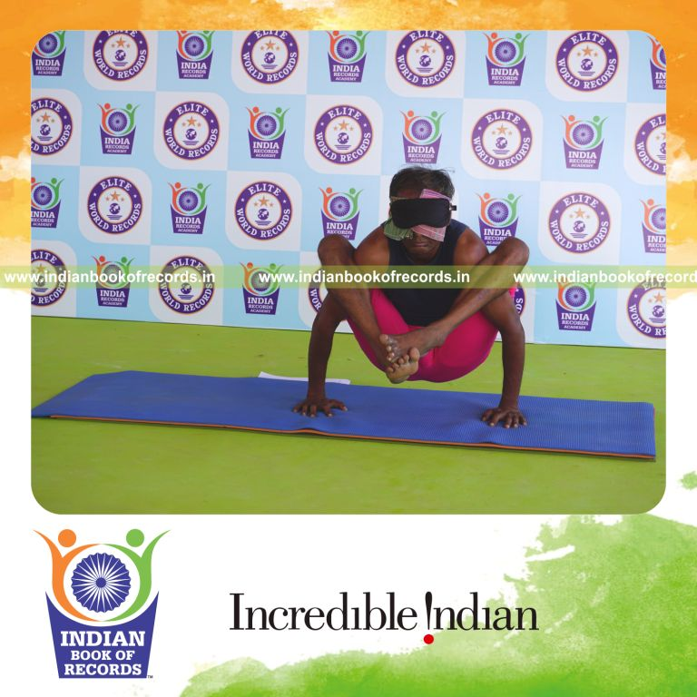 an individual holding bhujapidasana yoga pose blindfolded for the longest duration with strength and stability for a record in Indian Book of Records
