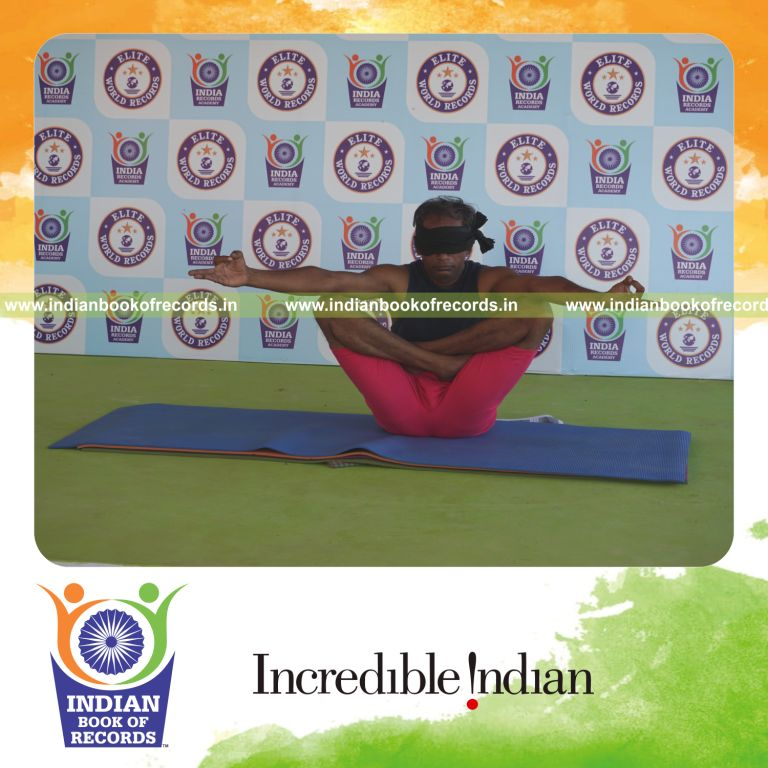 individual holding chinmudra thulangasana yoga pose blindfolded for record in Indian Book of Records