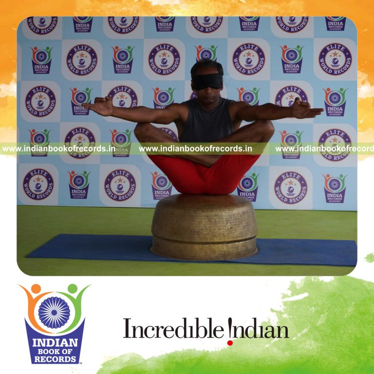 individual holding chinmudra thulangasana yoga pose blindfolded on a vessel for record in Indian Book of Records