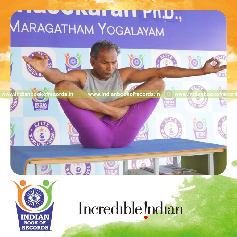 individual holding chinmudra thulangasana yoga pose on a table for record in Indian Book of Records