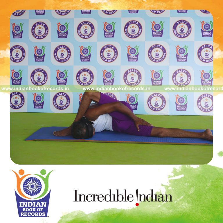 individual holding daksina ardha astavakrasana yoga pose blindfolded for record in Indian Book of Records