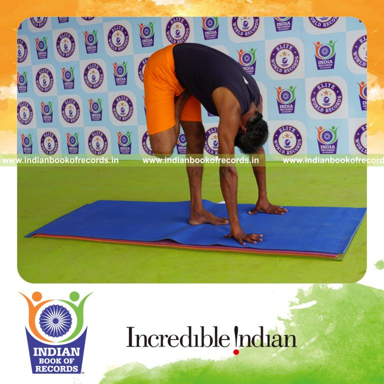 individual holding daksina ardha baddha padmottasana yoga pose blindfolded for record in Indian Book of Records