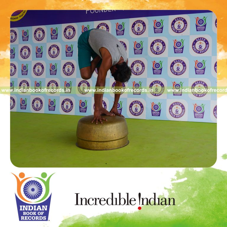 individual holding daksina ardha baddha padmottasana yoga pose blindfolded on a vessel for record in Indian Book of Records