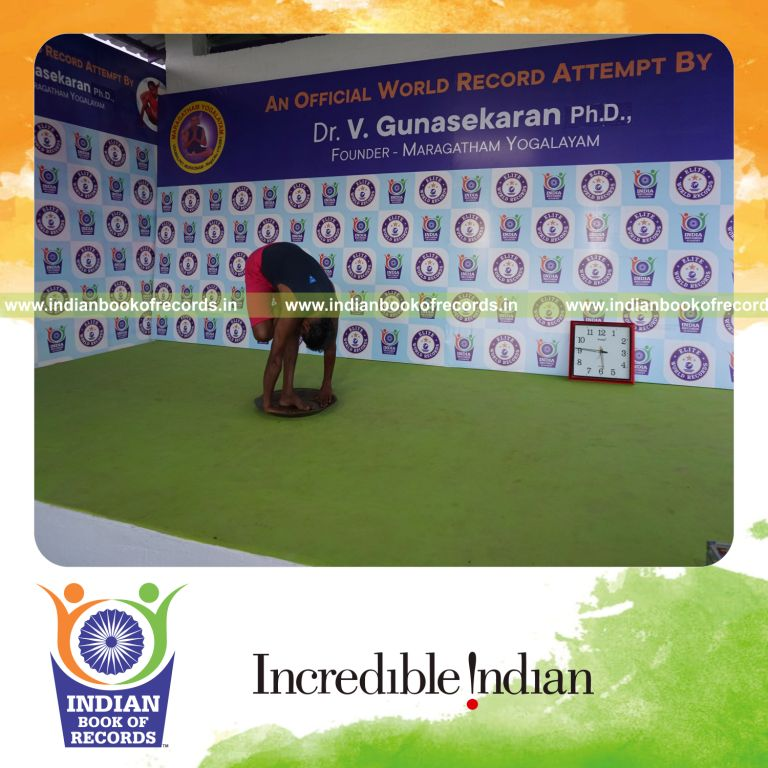 individual holding daksina ardha baddha padmottasana yoga pose on a brass plate for record in Indian Book of Records
