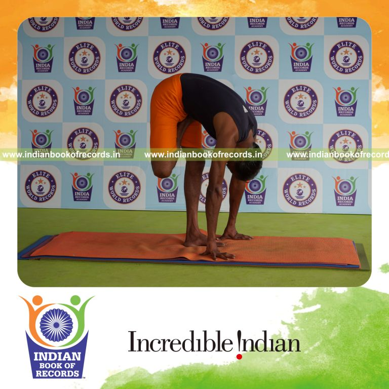 individual holding daksina ardha baddha padmottasana yoga pose for record in Indian Book of Records