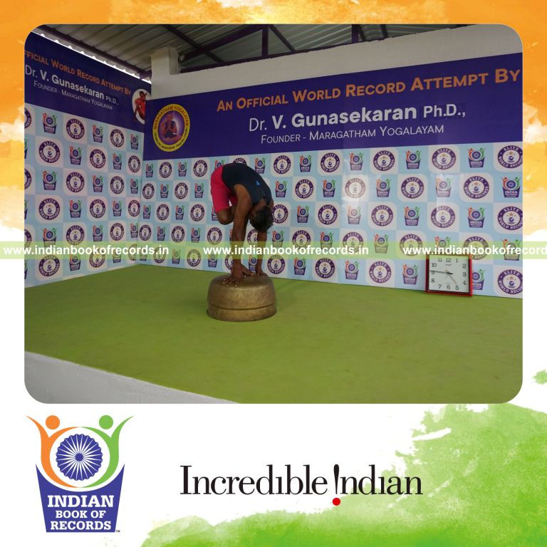 individual holding daksina ardha baddha padmottasana yoga pose on a vessel for record in Indian Book of Records