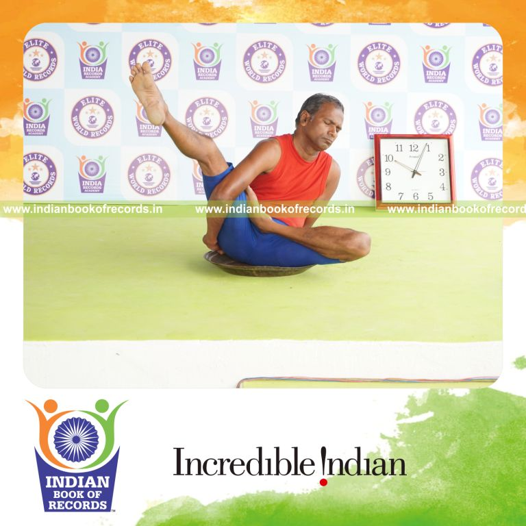 individual holding daksina ardha baddha parsva krounchasana yoga pose on a brass plate for record in Indian Book of Records