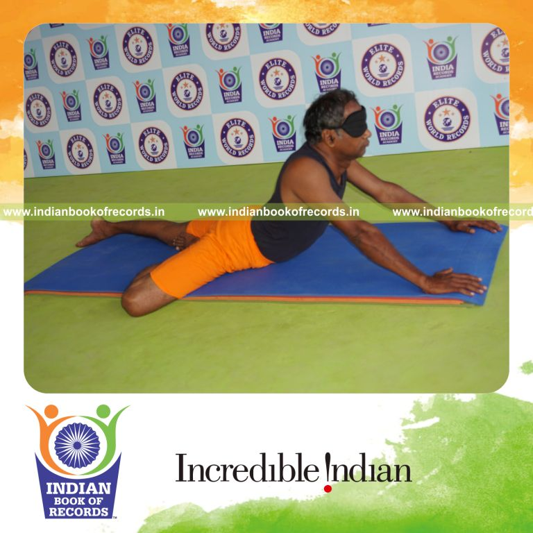 individual holding daksina ardha bhujangasana yoga pose blindfolded for record in Indian Book of Records