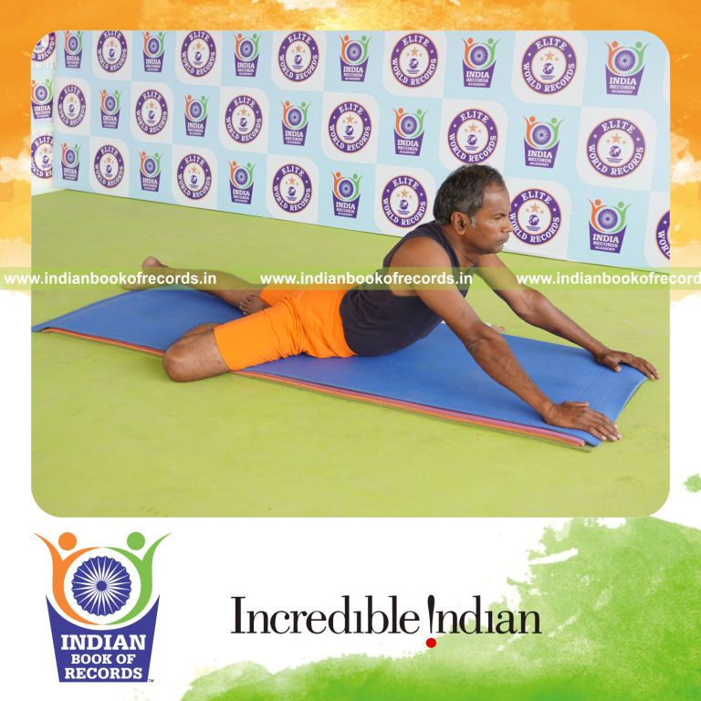 individual holding daksina ardha bhujangasana yoga pose for record in Indian Book of Records