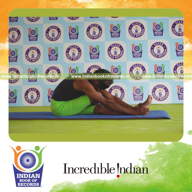 an individual holding daksina ardha janu sirsasana yoga pose blindfolded for the longest duration with flexibility and control for a record in Indian Book of Records