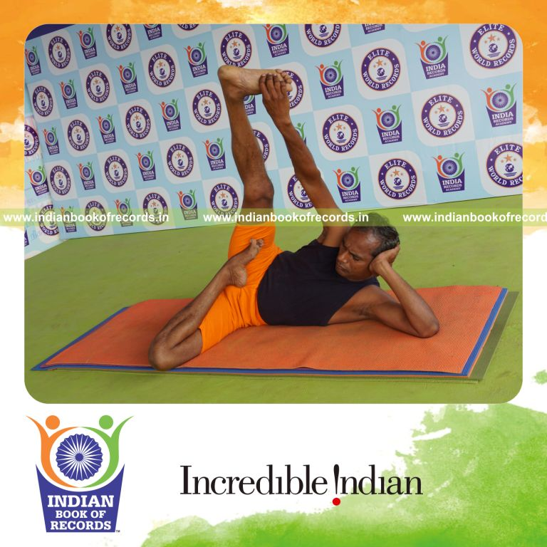 individual holding daksina ardha padma anantasana yoga pose for record in Indian Book of Records