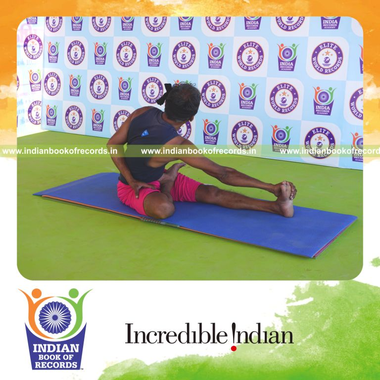an individual holding daksina ardha padma matsyendrasana yoga pose blindfolded for the longest duration with flexibility and control for a record in Indian Book of Records