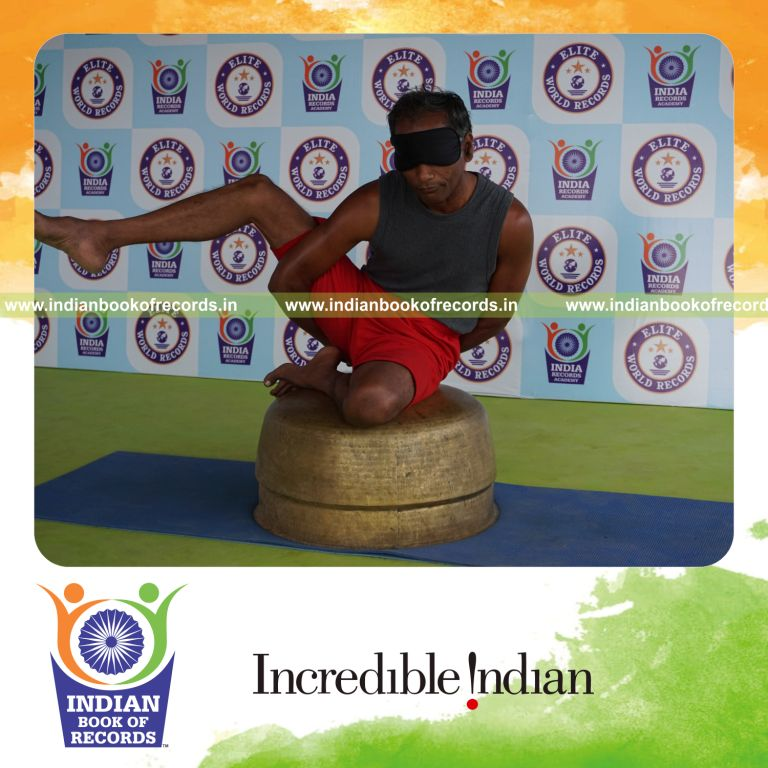 individual holding daksina ardha parsva krounchasana yoga pose blindfolded on a vessel for record in Indian Book of Records