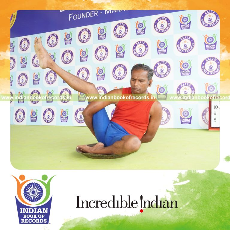 individual holding daksina ardha parsva krounchasana yoga pose on a brass plate for record in Indian Book of Records