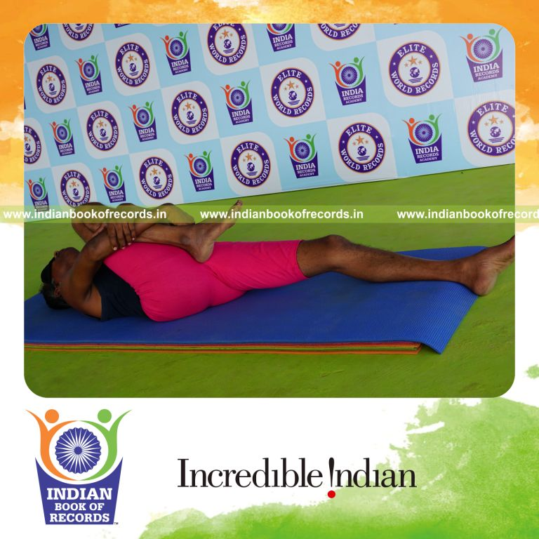 individual holding daksina ardha pavanamuktasana yoga pose blindfolded for record in Indian Book of Records