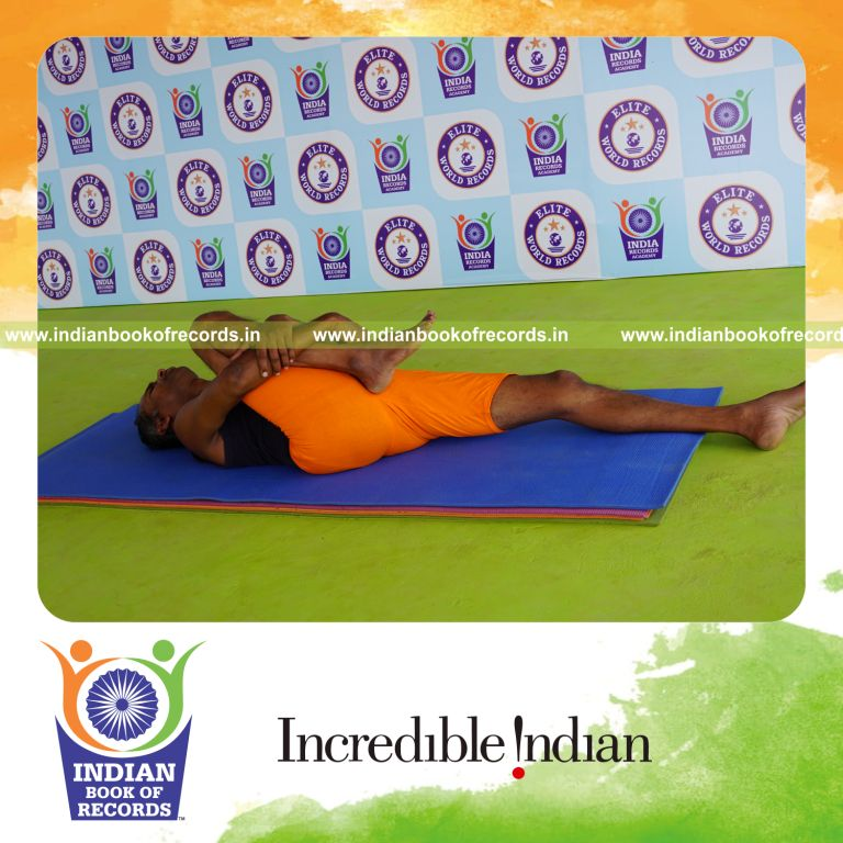 individual holding daksina ardha pavanamuktasana yoga pose for record in Indian Book of Records