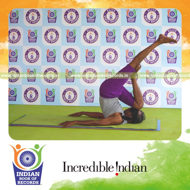 individual holding daksina ardha salamba sarvangasana yoga pose blindfolded for record in Indian Book of Records