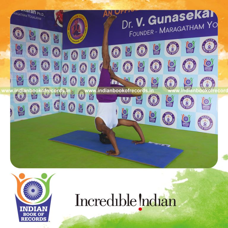 individual holding daksina ardha salamba sirsasana second type yoga pose blindfolded for record in Indian Book of Records