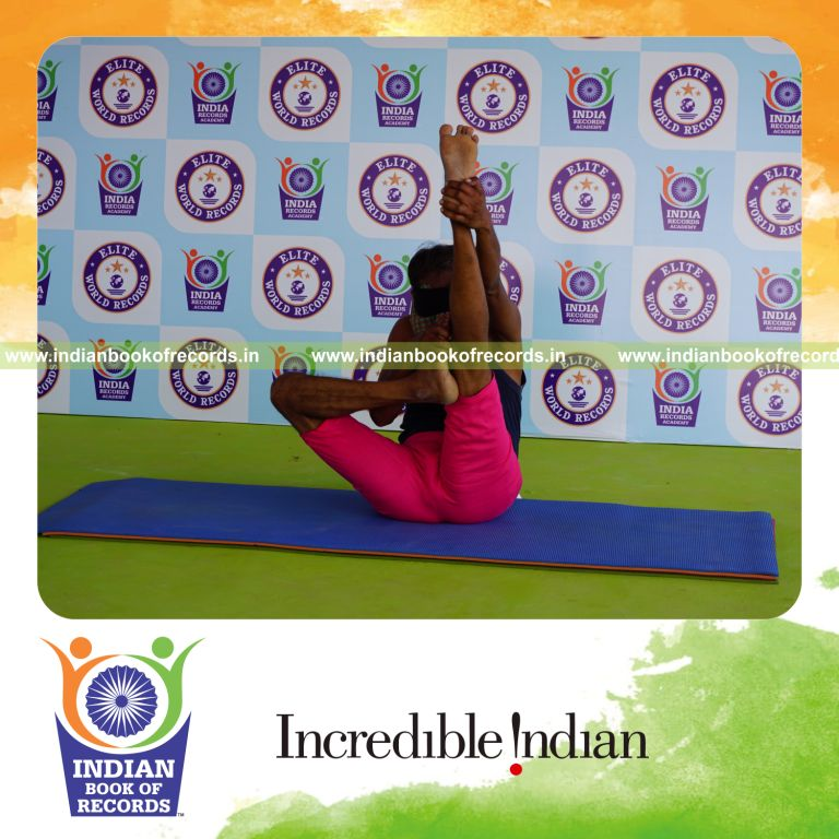 an individual holding daksina ardha urdhva mukha paschimottanasana yoga pose blindfolded for the longest duration with flexibility and control for a record in Indian Book of Records