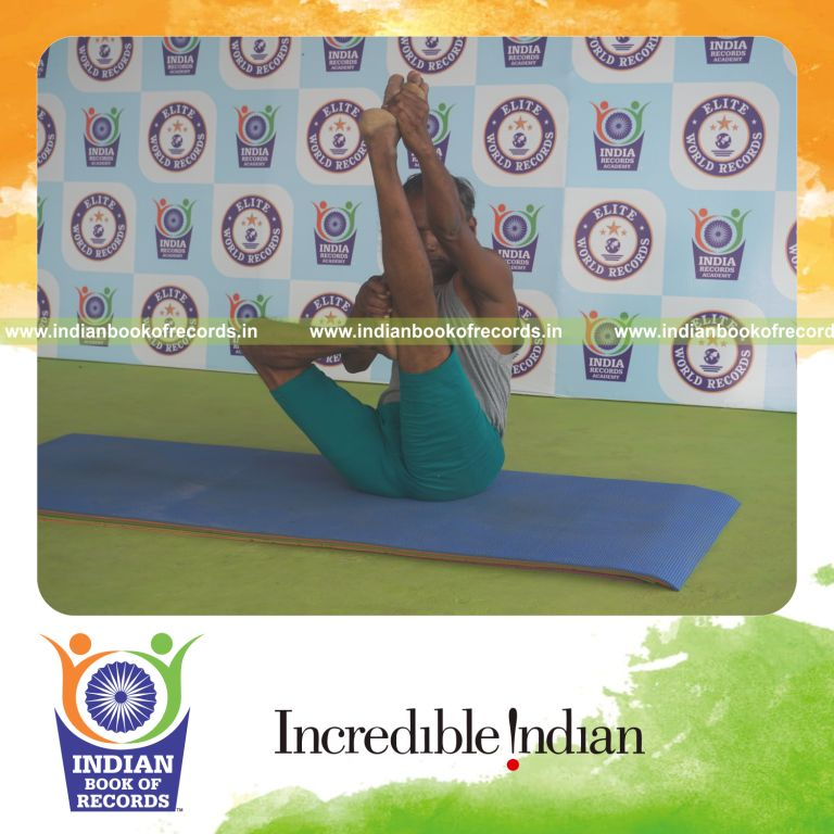individual holding daksina ardha urdhva mukha paschimottanasana yoga pose for record in Indian Book of Records