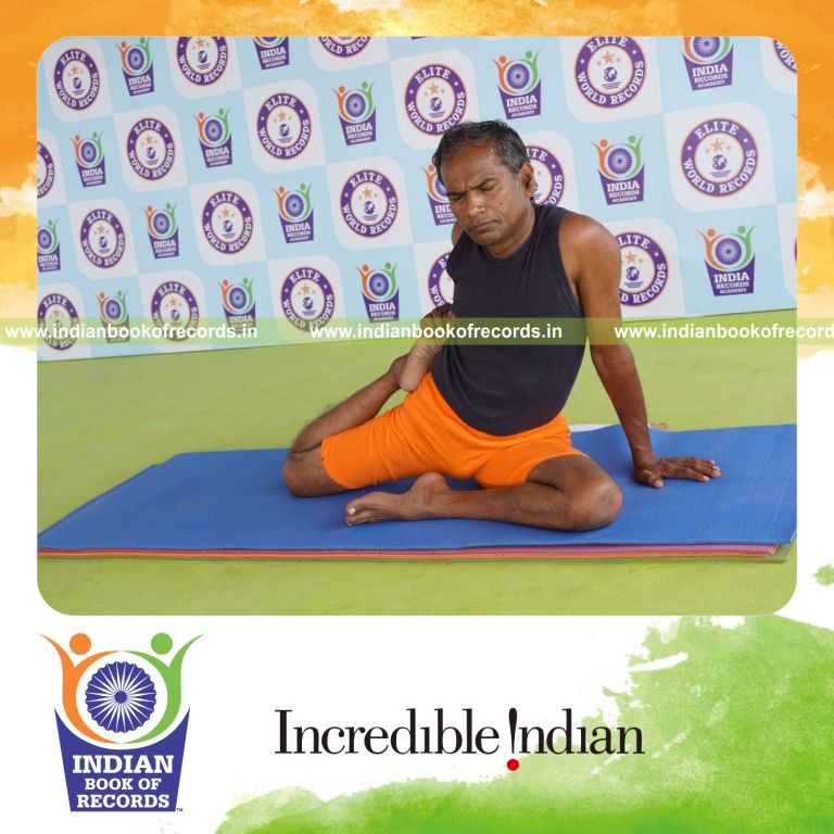 individual holding daksina ardha vamadevasana yoga pose for record in Indian Book of Records