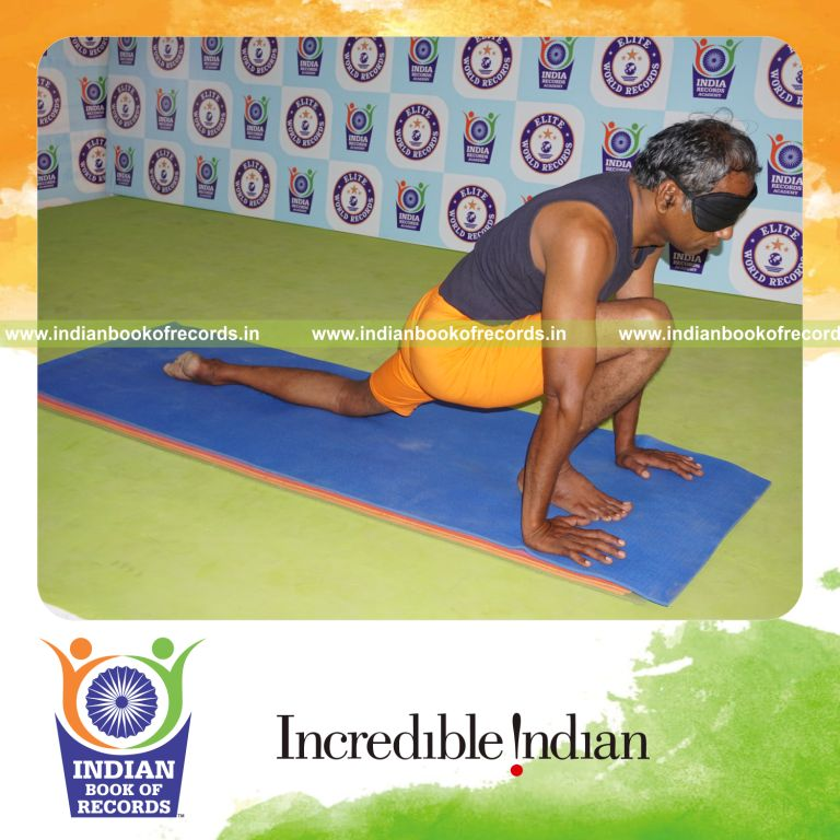 individual holding daksina asva chanjalanasana yoga pose blindfolded for record in Indian Book of Records