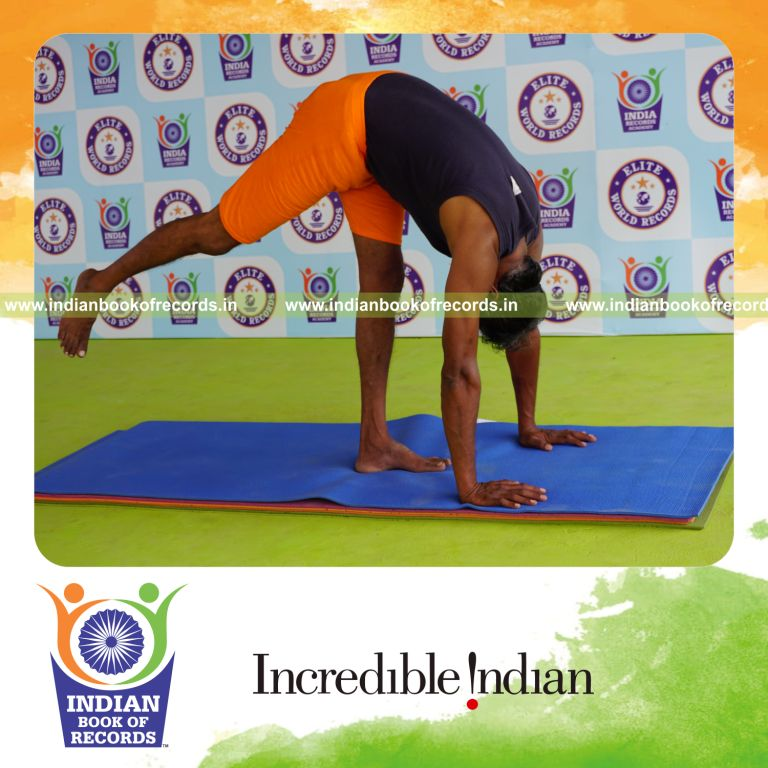 individual holding daksina ekapada padahasthasana yoga pose blindfolded for record in Indian Book of Records
