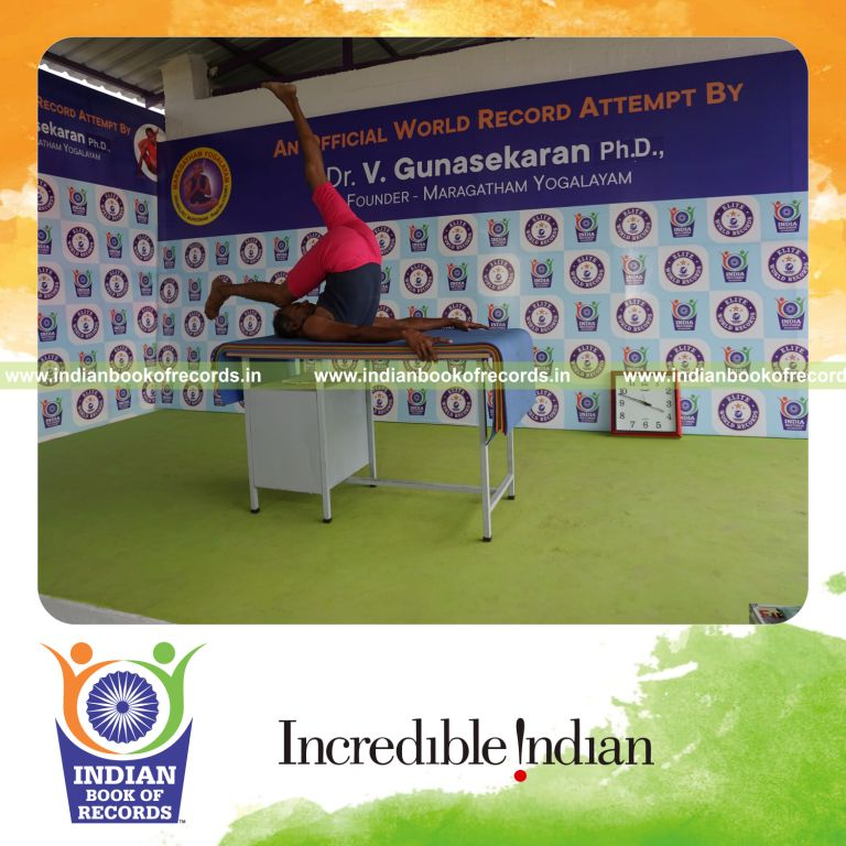 individual holding daksina ekapada salamba sarvangasana yoga pose on a table for record in Indian Book of Records