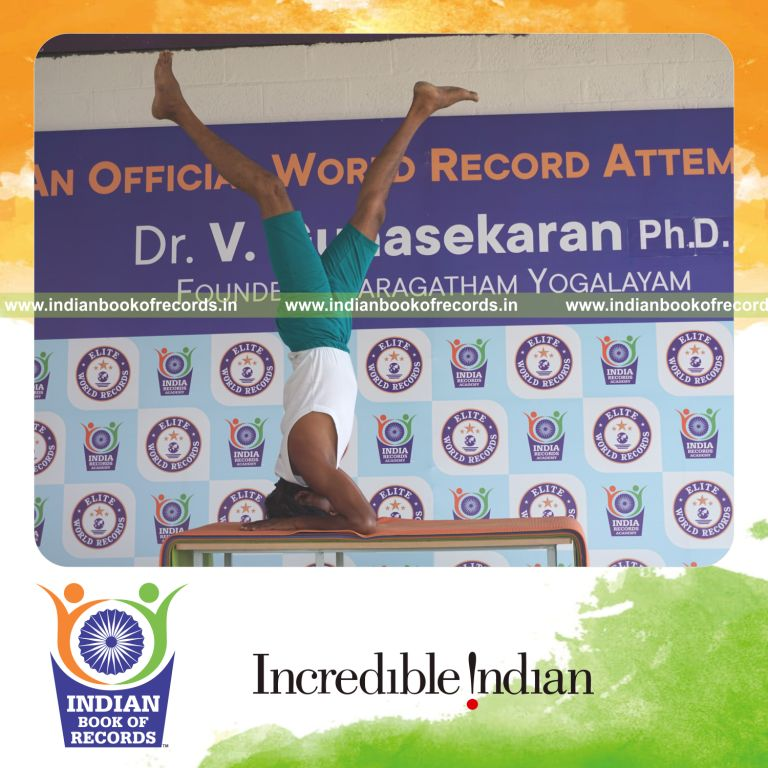 an individual holding daksina ekapada salamba sirsasana yoga pose blindfolded on a table continuously for the longest duration with balance and control for a record in Indian Book of Records