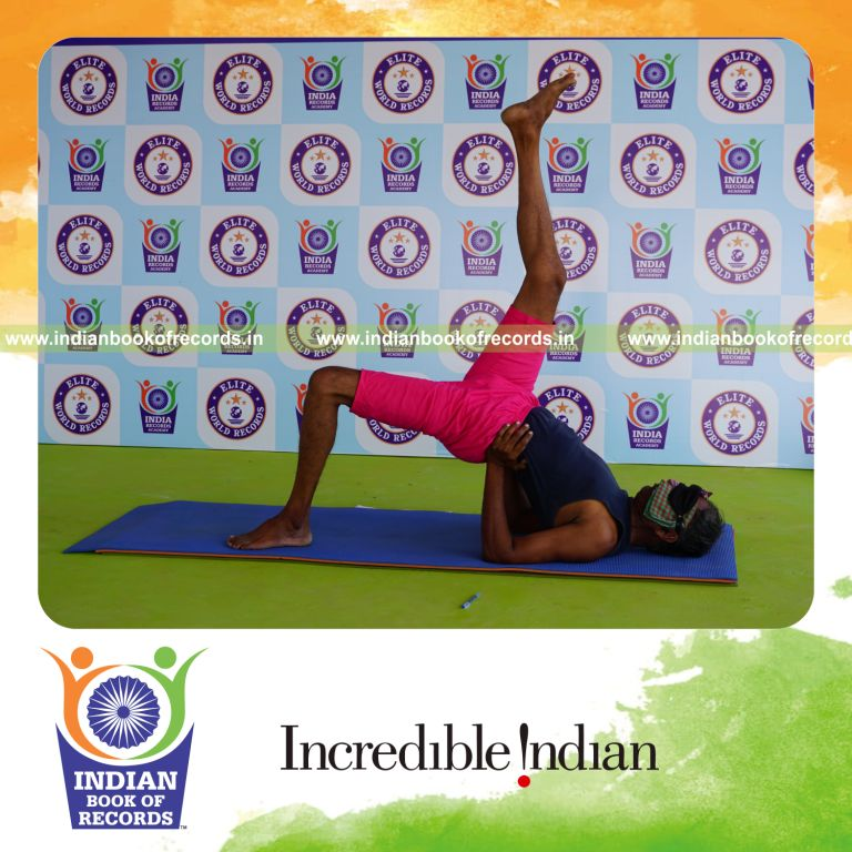 an individual holding daksina ekapada setu bandha sarvangasana yoga pose blindfolded for the longest duration with stability and control for a record in Indian Book of Records