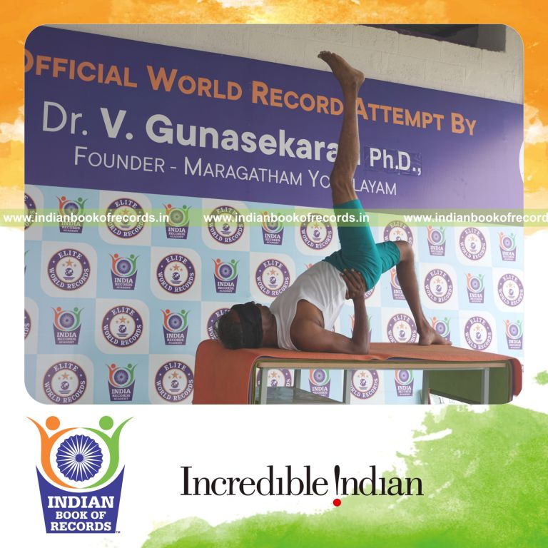 an individual holding daksina ekapada setu bandha sarvangasana yoga pose blindfolded on a table continuously for the longest duration with balance and control for a record in Indian Book of Records