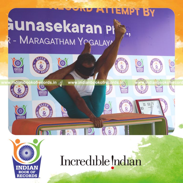 an individual holding daksina ekapada sirasa krounchasana yoga pose blindfolded on a table continuously for the longest duration with balance and control for a record in Indian Book of Records