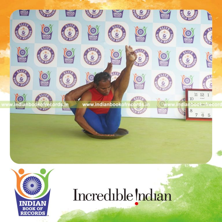 individual holding daksina ekapada sirasa krounchasana yoga pose on a brass plate for record in Indian Book of Records