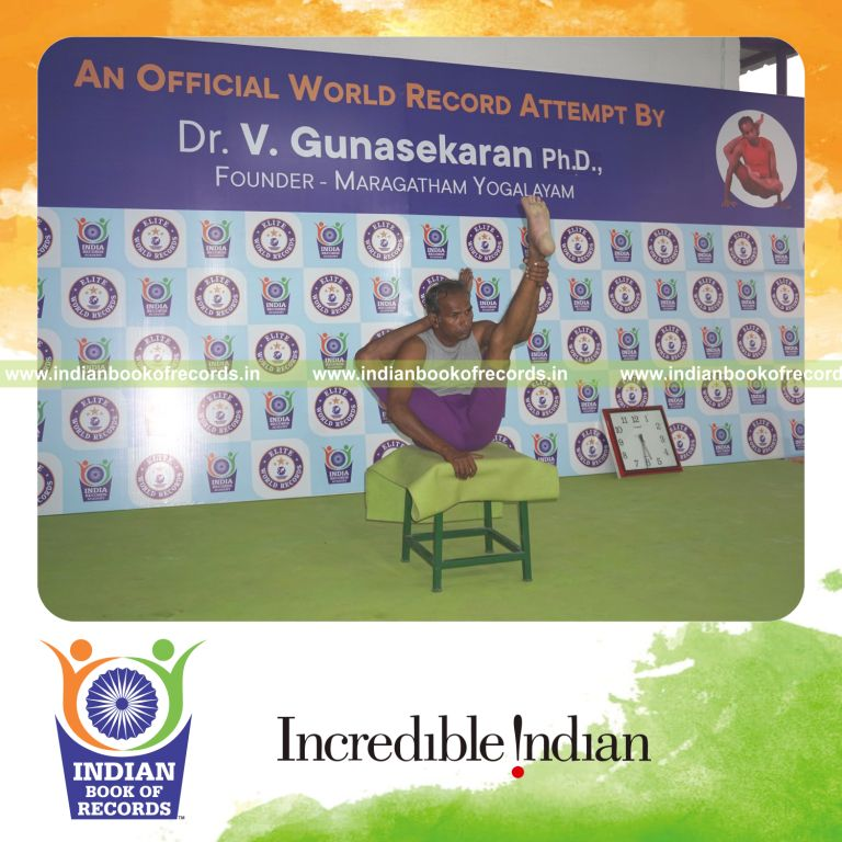 individual holding daksina ekapada sirasa krounchasana yoga pose on a stool for record in Indian Book of Records