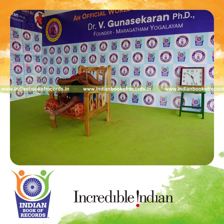 individual holding daksina ekapada skandasana yoga pose on a chair for record in Indian Book of Records