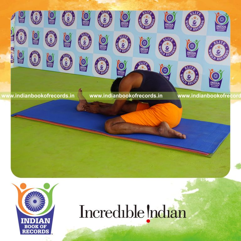 individual holding daksina gomukha janu sirsasana yoga pose blindfolded for record in Indian Book of Records