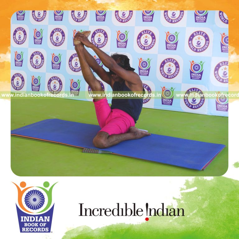 an individual holding daksina gomukha krounchasana yoga pose blindfolded for the longest duration with flexibility and control for a record in Indian Book of Records