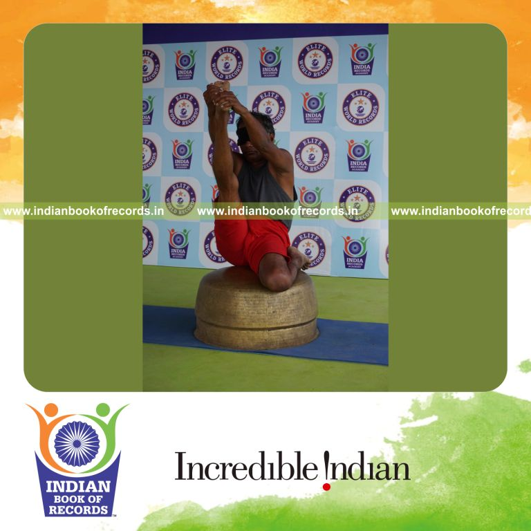 individual holding daksina gomukha krounchasana yoga pose blindfolded on a vessel for record in Indian Book of Records