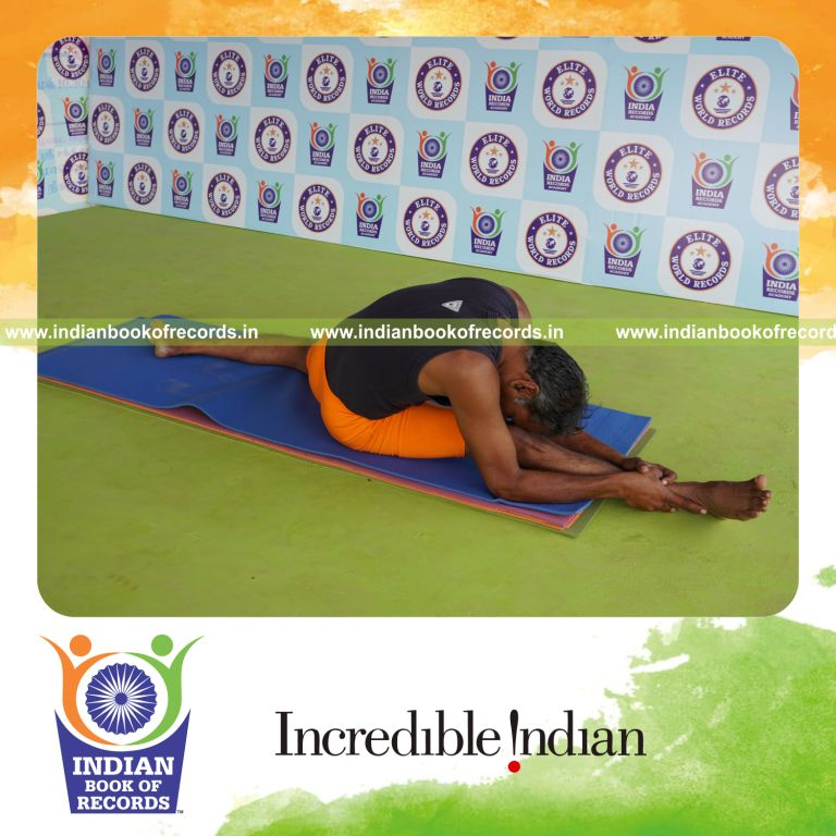 individual holding daksina hanumana paschimottanasana yoga pose for record in Indian Book of Records