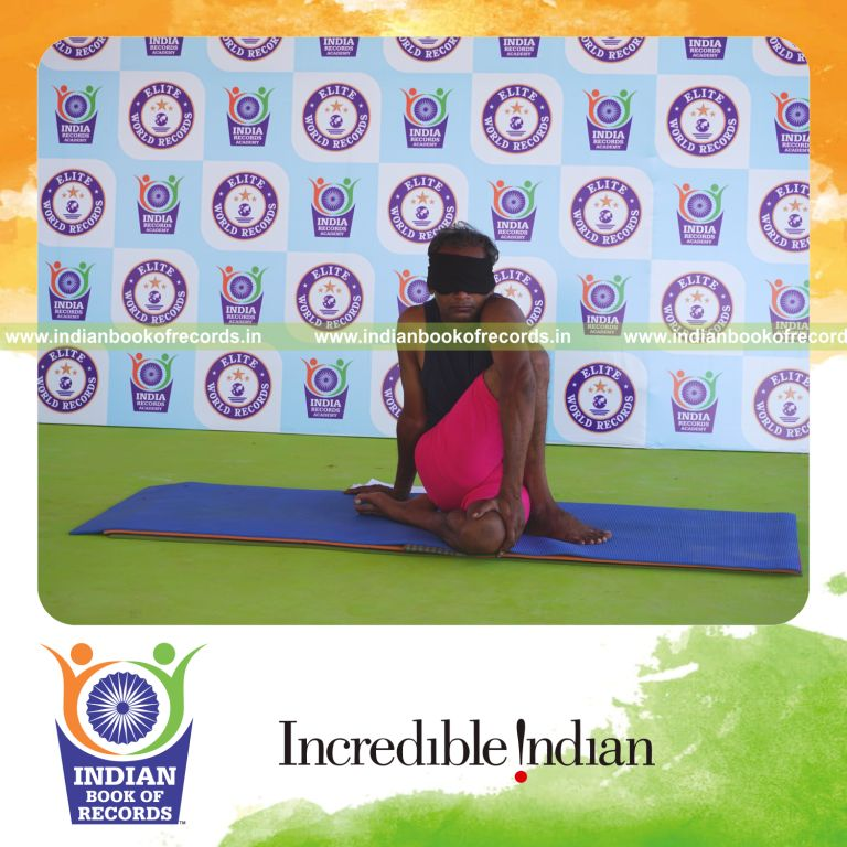 an individual holding daksina janu ardha matsyendrasana yoga pose blindfolded for the longest duration with flexibility and control for a record in Indian Book of Records