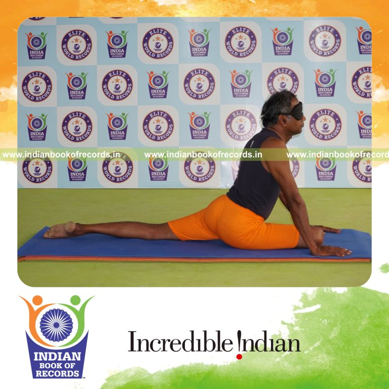 individual holding daksina janu bhujangasana yoga pose blindfolded for record in Indian Book of Records