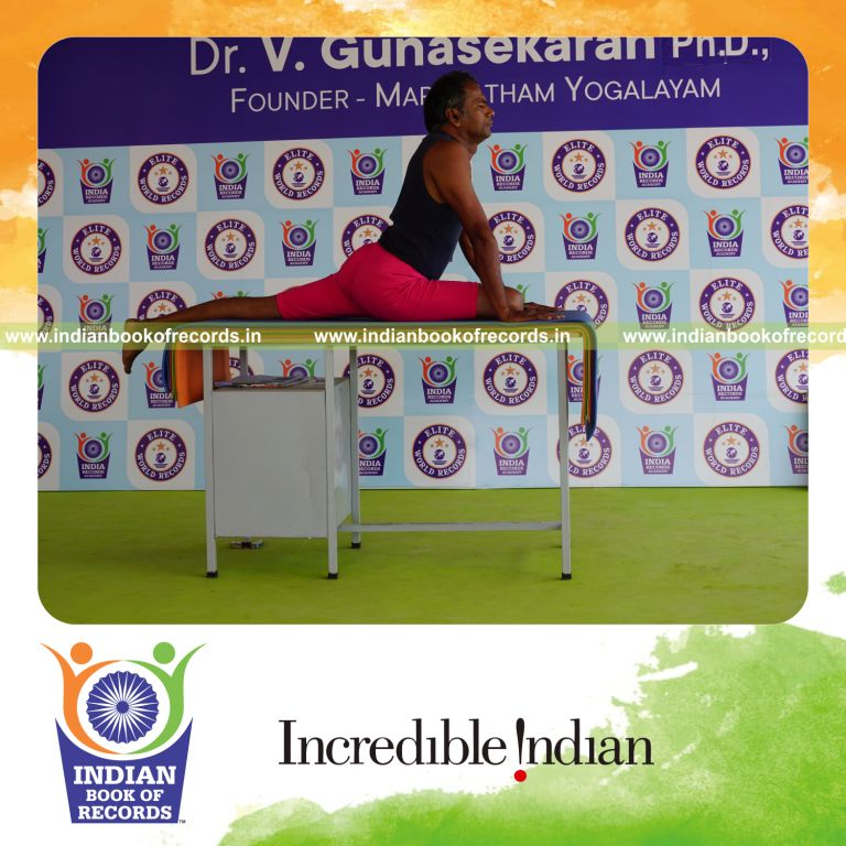 individual holding daksina janu bhujangasana yoga pose on a table for record in Indian Book of Records