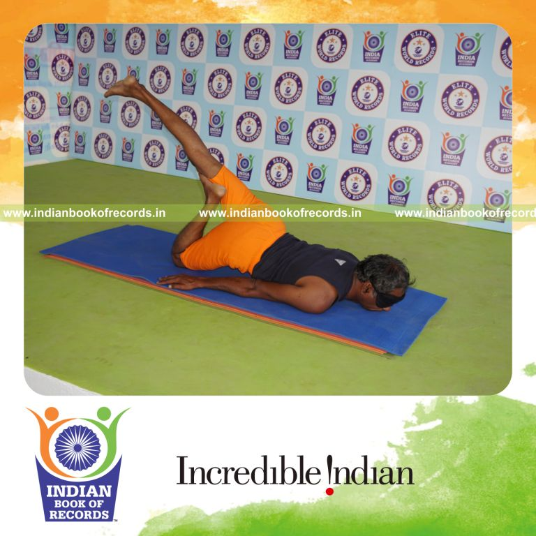 individual holding daksina janu salabhasana yoga pose blindfolded for record in Indian Book of Records